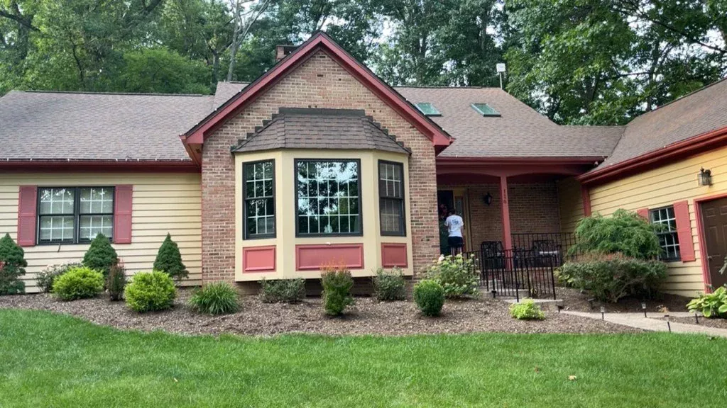 Landscaped brick Pennsylvania home with sparkling clean windows