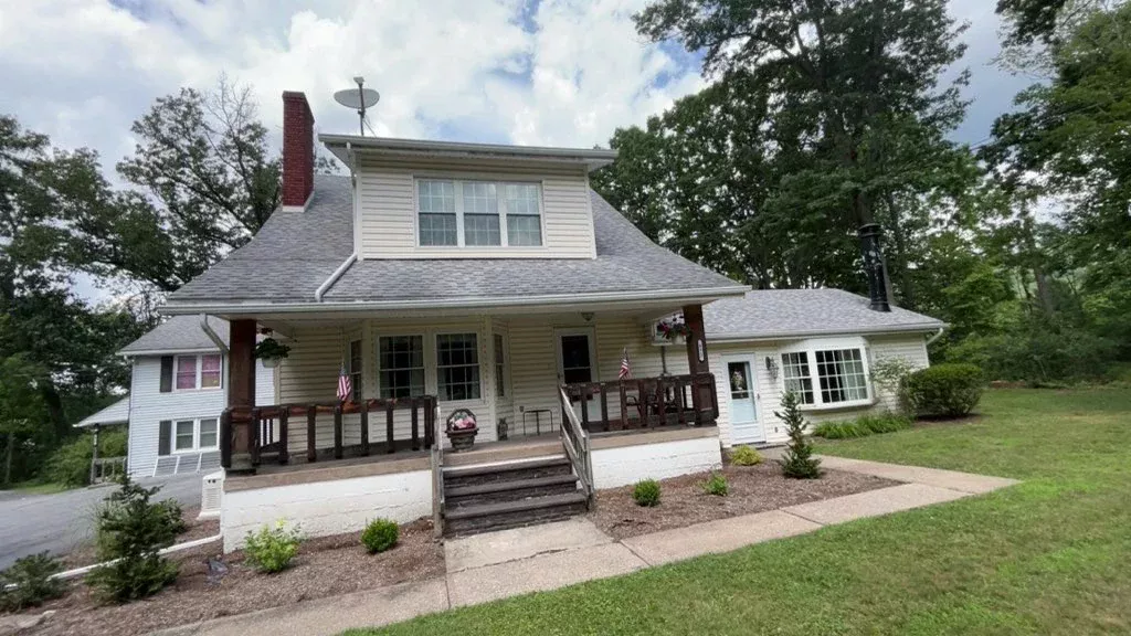 Two-story Pennsylvania home with clean windows and a covered front porch